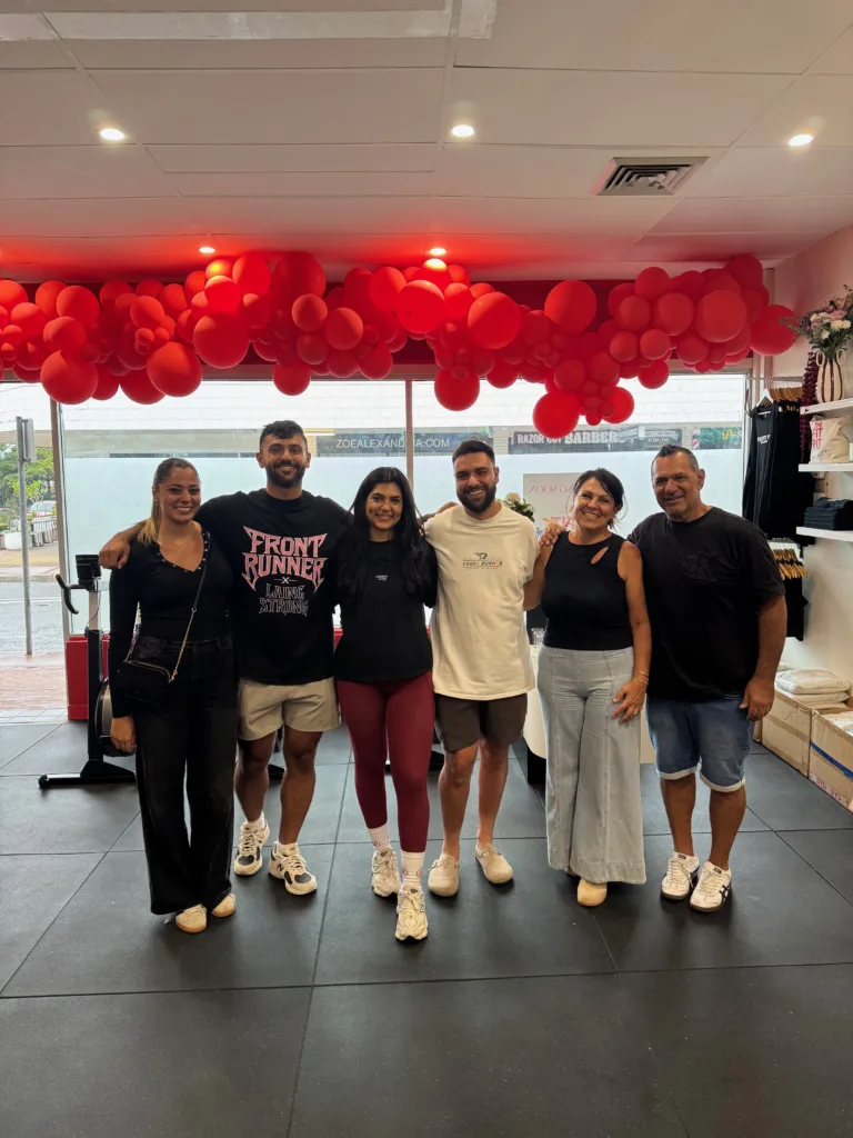 Tia with her family on her gym's opening night.