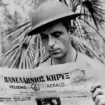 Xenophon Castrisos (Castles), an aerial photographer with the Royal Australian Air Force, reads the Hellenic Herald, a Greek-Australian newspaper.