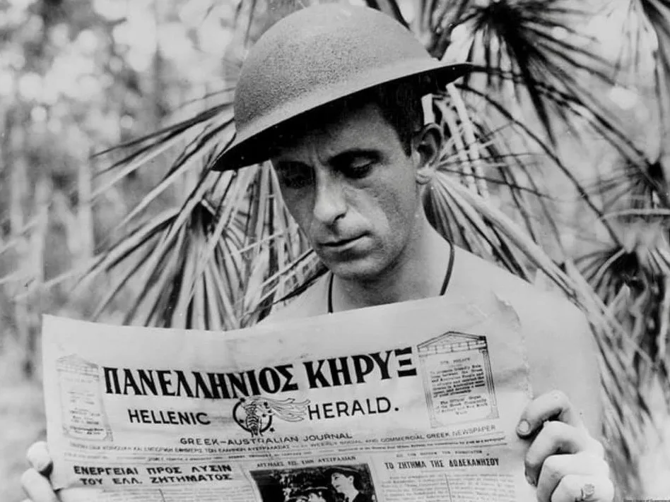 Xenophon Castrisos (Castles), an aerial photographer with the Royal Australian Air Force, reads the Hellenic Herald, a Greek-Australian newspaper.