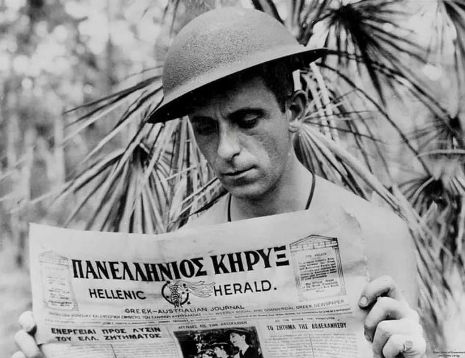 Xenophon Castrisos (Castles), an aerial photographer with the Royal Australian Air Force, reads the Hellenic Herald, a Greek-Australian newspaper.