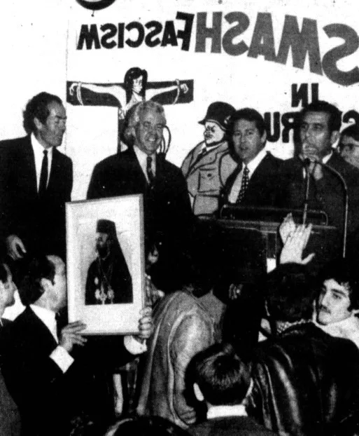Cyprus Community NSW President Savas Mourouzis addresses a Town Hall gathering alongside Minister Bill Morrison on July 21 1974