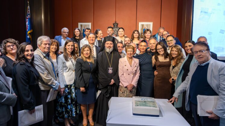 former and current employees of the greek herald with the officials cutting a cake